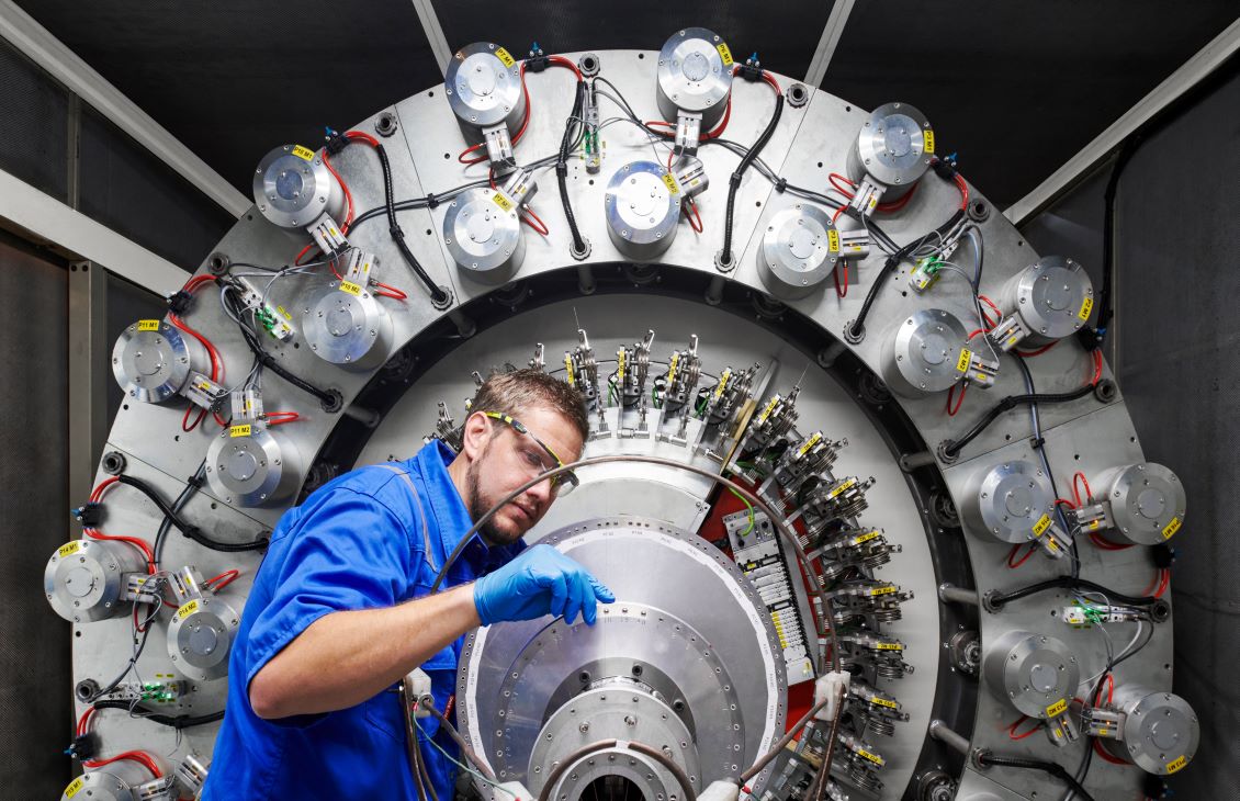 SLB employees studying a piece of equipment