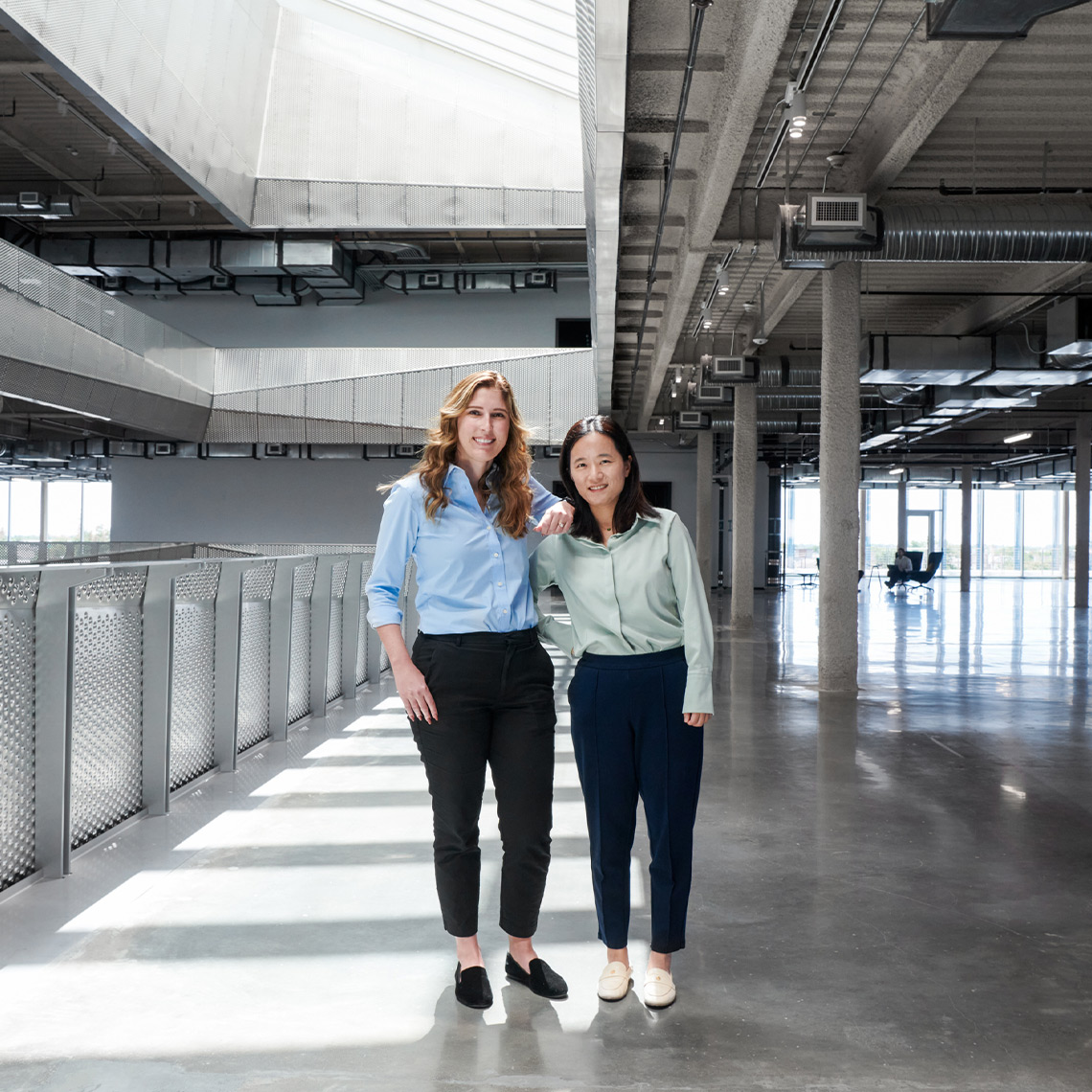 Two women standing in a hallway