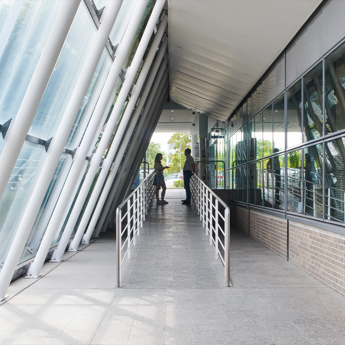 Two people in a hallway with a ramp