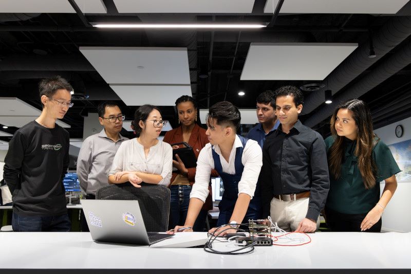 IT professionals looking at a laptop