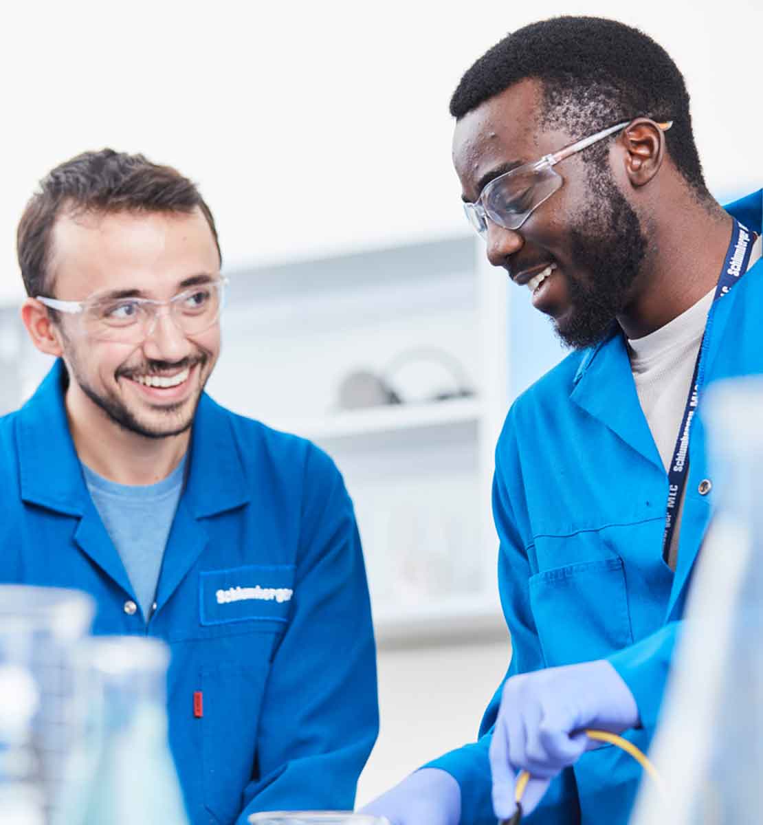 Schlumberger employees work together in lab.