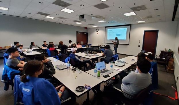 Oil-x-seed classroom with high school students listening to a presentation given by a Schlumberger Employee