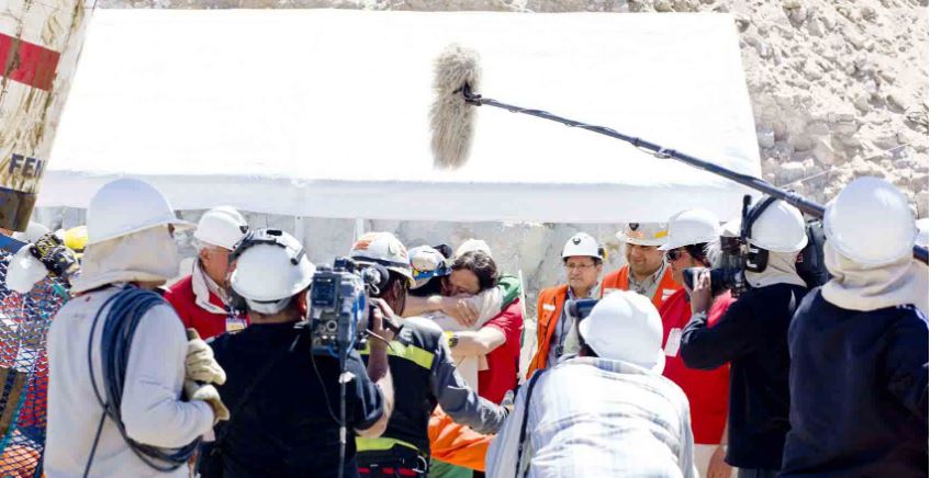 International media and onlookers cheer as the miners are lifted to the surface after being trapped in the mine for 69 days. 