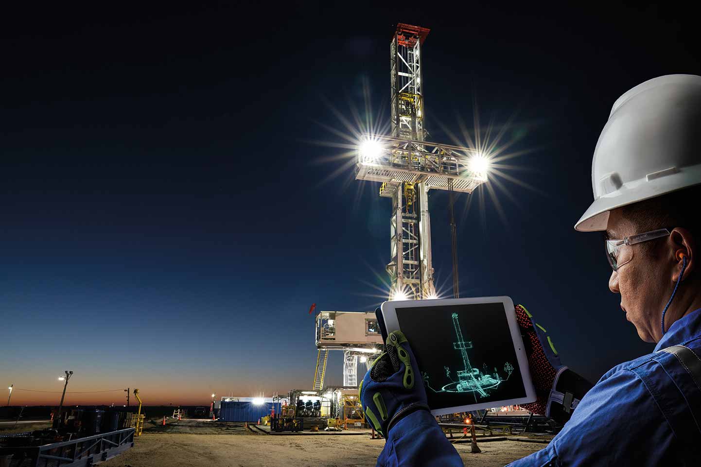 Worker views iPad with data at a Schlumberger rig site.