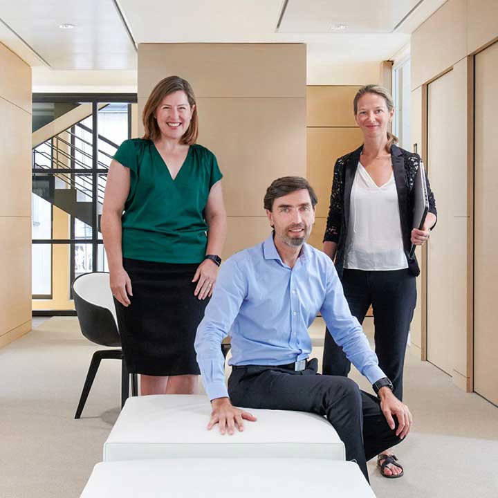 Photo of a man and two women at the office in Paris, France