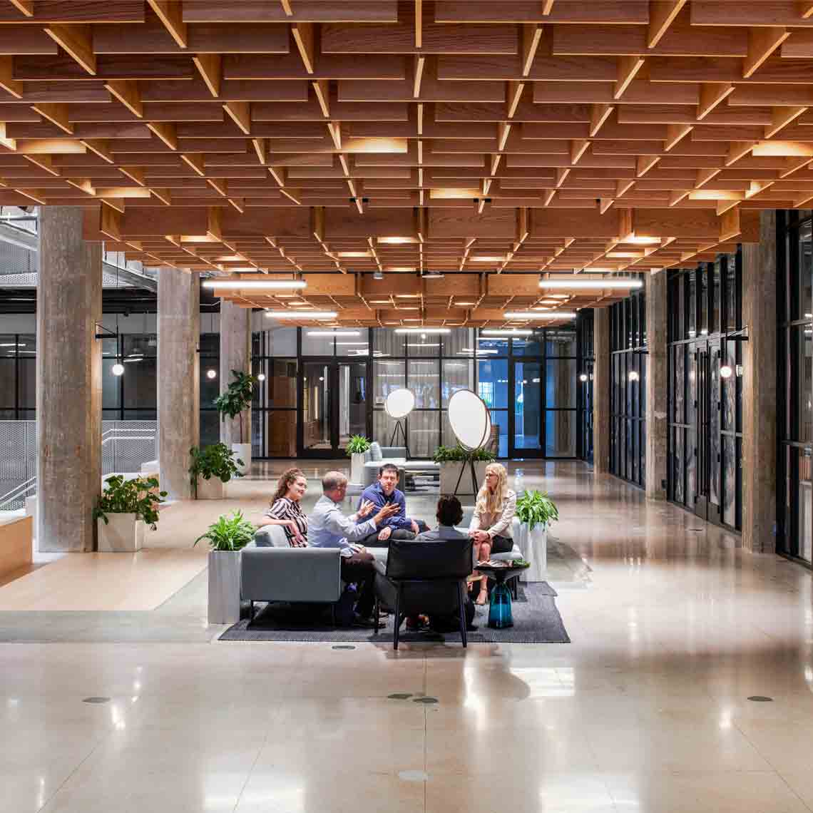 Photo of team of people collaborating in an open-architecture environment (Tier 1_Office_Houston_AML_5041)